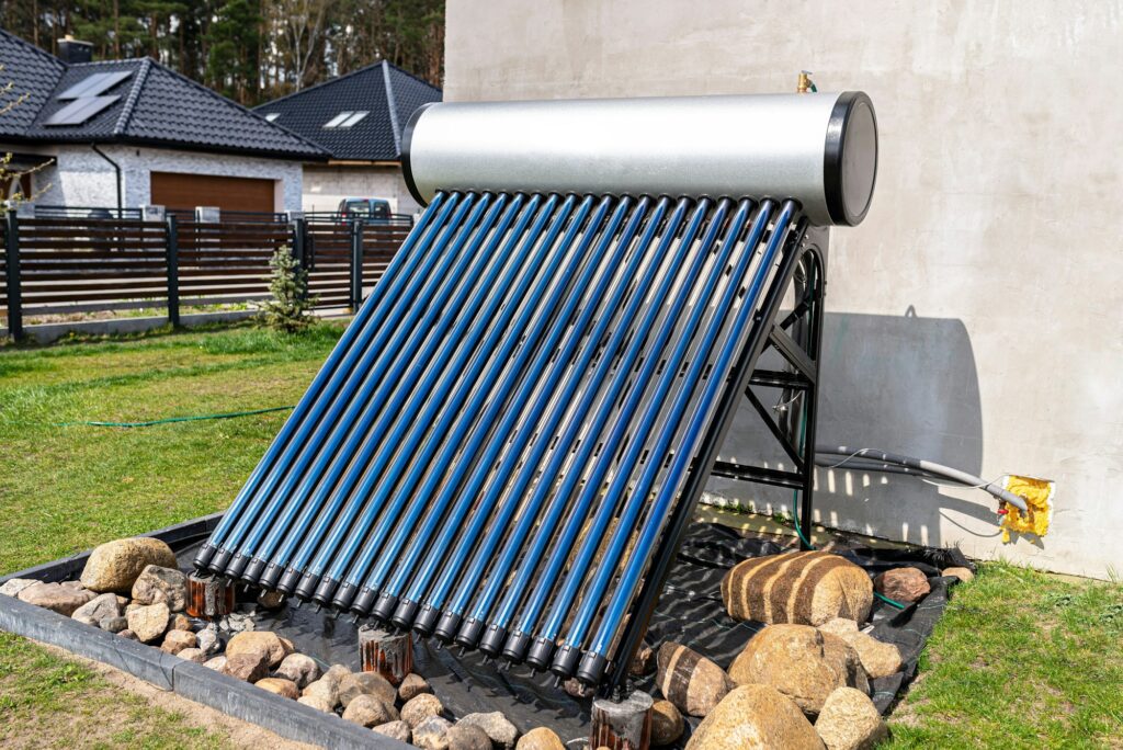 A modern solar pressure collector to heat domestic hot water, standing in front of the house